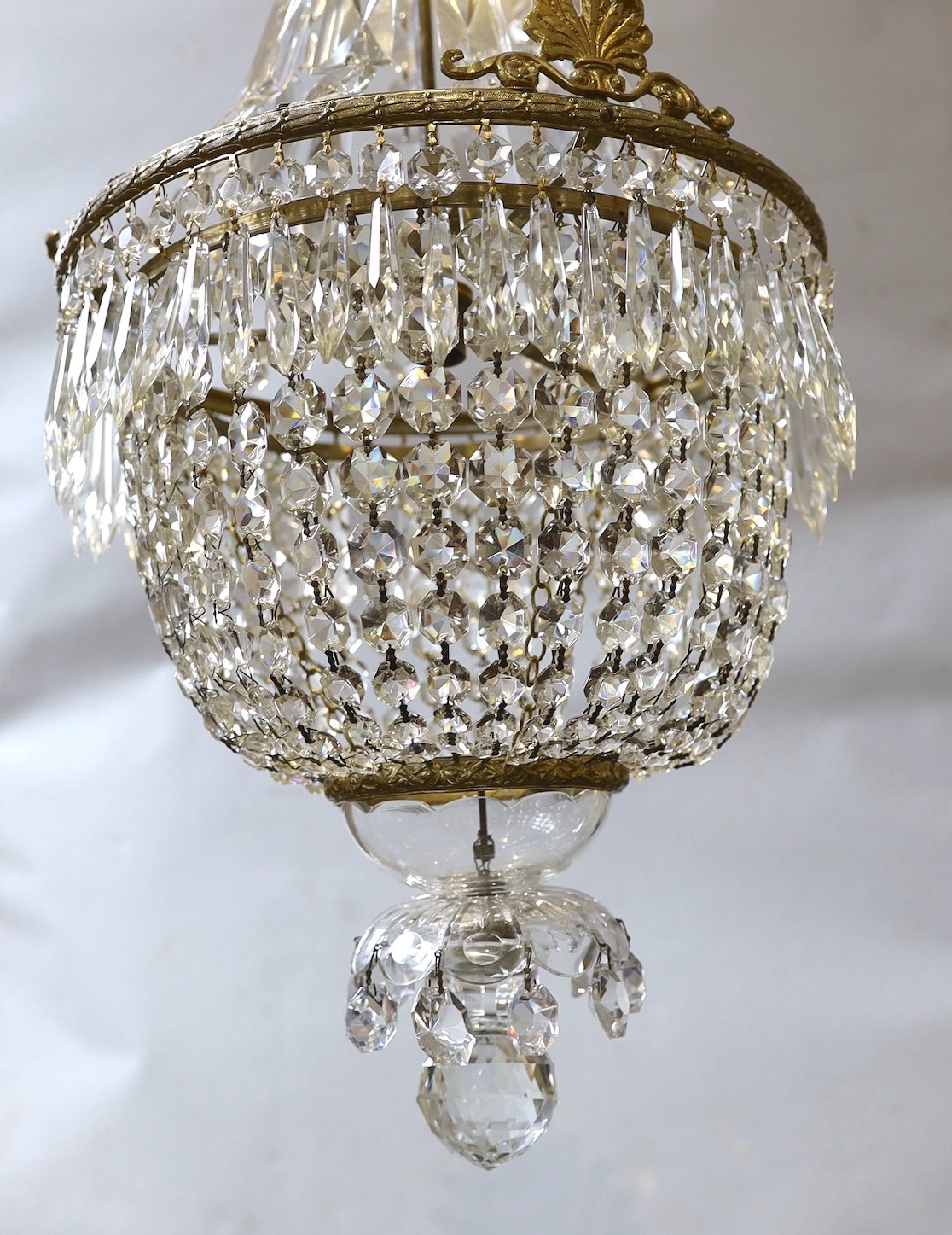 A brass bag shaped ceiling light hung faceted bead and spear drops, height approximately 80 cms.